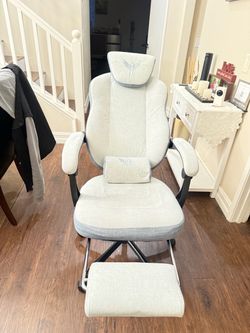 Fabric gaming chair with footrest and adjustable headrest