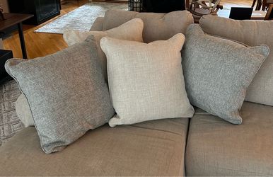 4 large, neutral-colored decorative sofa pillows