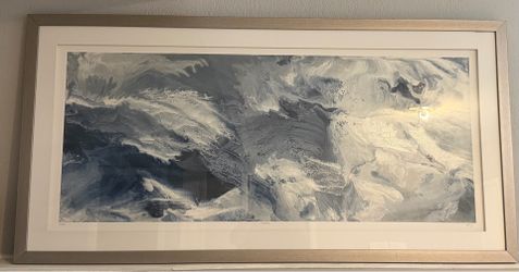 Litton Lane abstract wall art, featuring a blue and white ocean-inspired design framed in a silver metallic finish