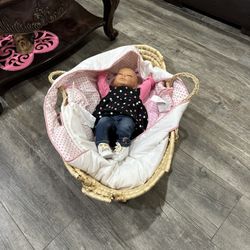 really cute baby doll with a lot of outfits and bed 