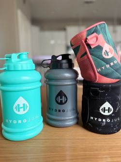 Two 73oz hydrojug water bottles with sleeves