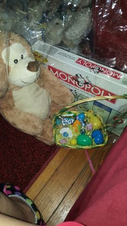 Monopoly game and basket filled with plush bear