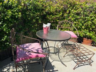Wrought  iron patio set – two chairs, glass, top table and matching ottoman. $200.