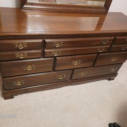 Very nice, wood 8 drawer Dresser With Mirror.  Measures  60" Wide X 33 Tall  X 18" Deep.