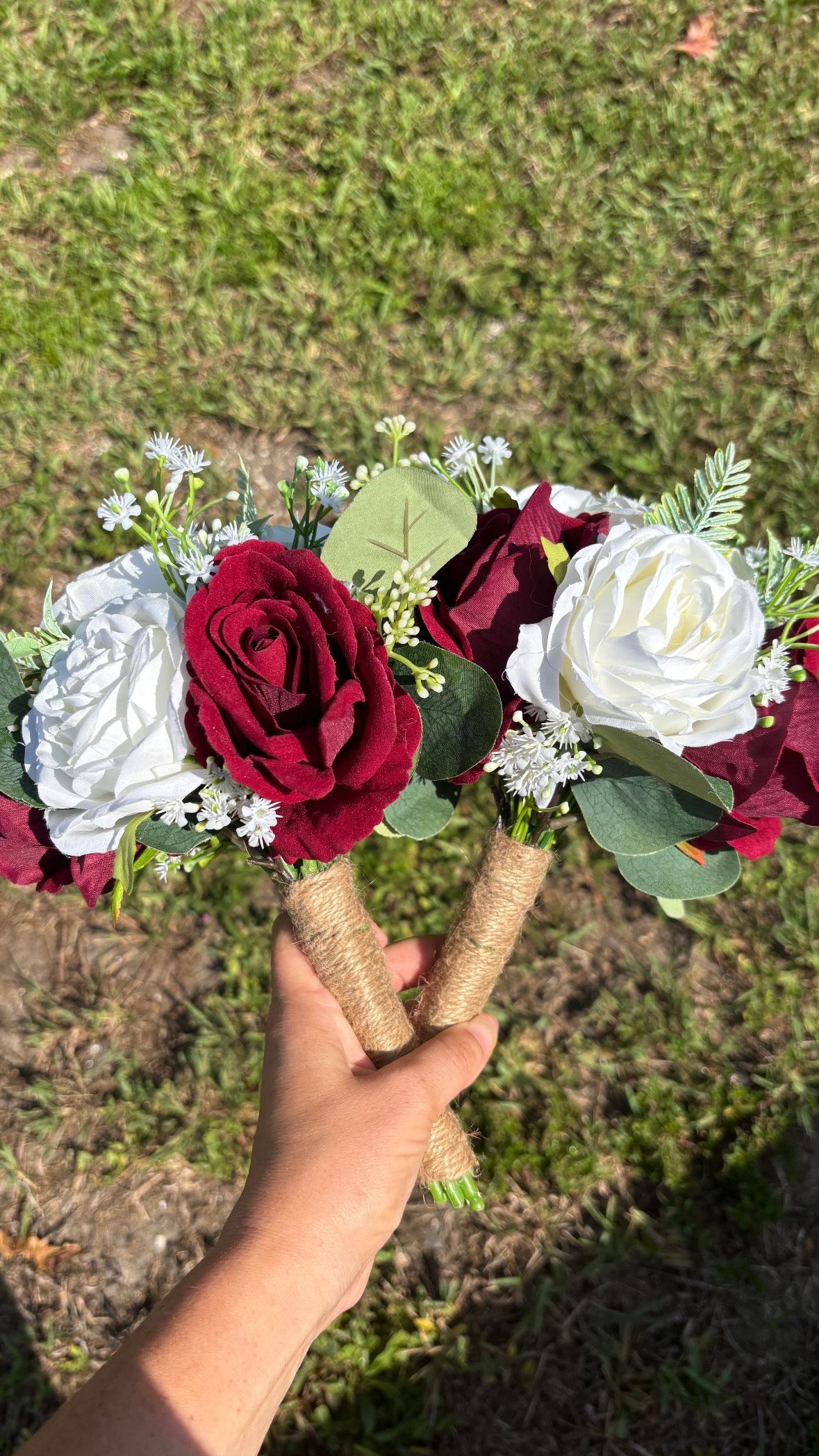 Two faux rose bouquets with eucalyptus