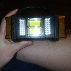 Flash Light With 4 Light Settings And A Solar Panel Phone Charger.