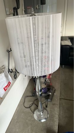 Beautiful elegant floor lamp with a chrome finish, crystal accents, and a white textured fabric shade. Very stylish and perfect for a living room, bed