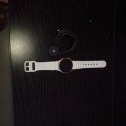Samsung Galaxy Watch7 with a white sport band. 
