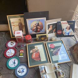 I am selling 19 Coca-Cola collectible pieces, including a Coca-Cola blanket and various framed items. I am asking for $70 for everything, firm price.
