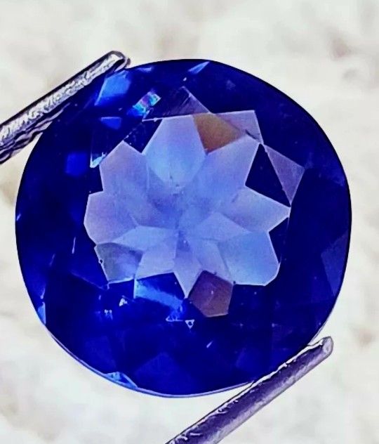 9.10 Ct Loose Blue Zoisite Tanzanite-Like Excellent Round Cut Gemstone. The product is a 9.10 carat natural loose blue zoisite tanzanite-like gemstone