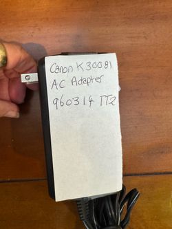 This is a Canon K30081 AD-300 AC Adapter power supply unit