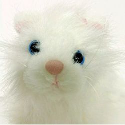 Ganz white persian cat plush. Good condition and smoke free home.  Measures 7" T X 9 " L 