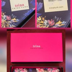 Trina Turk "Trina Wallet" with the style number TTT-LWB01-NFL. The wallet features a multi-color floral pattern on a black background
