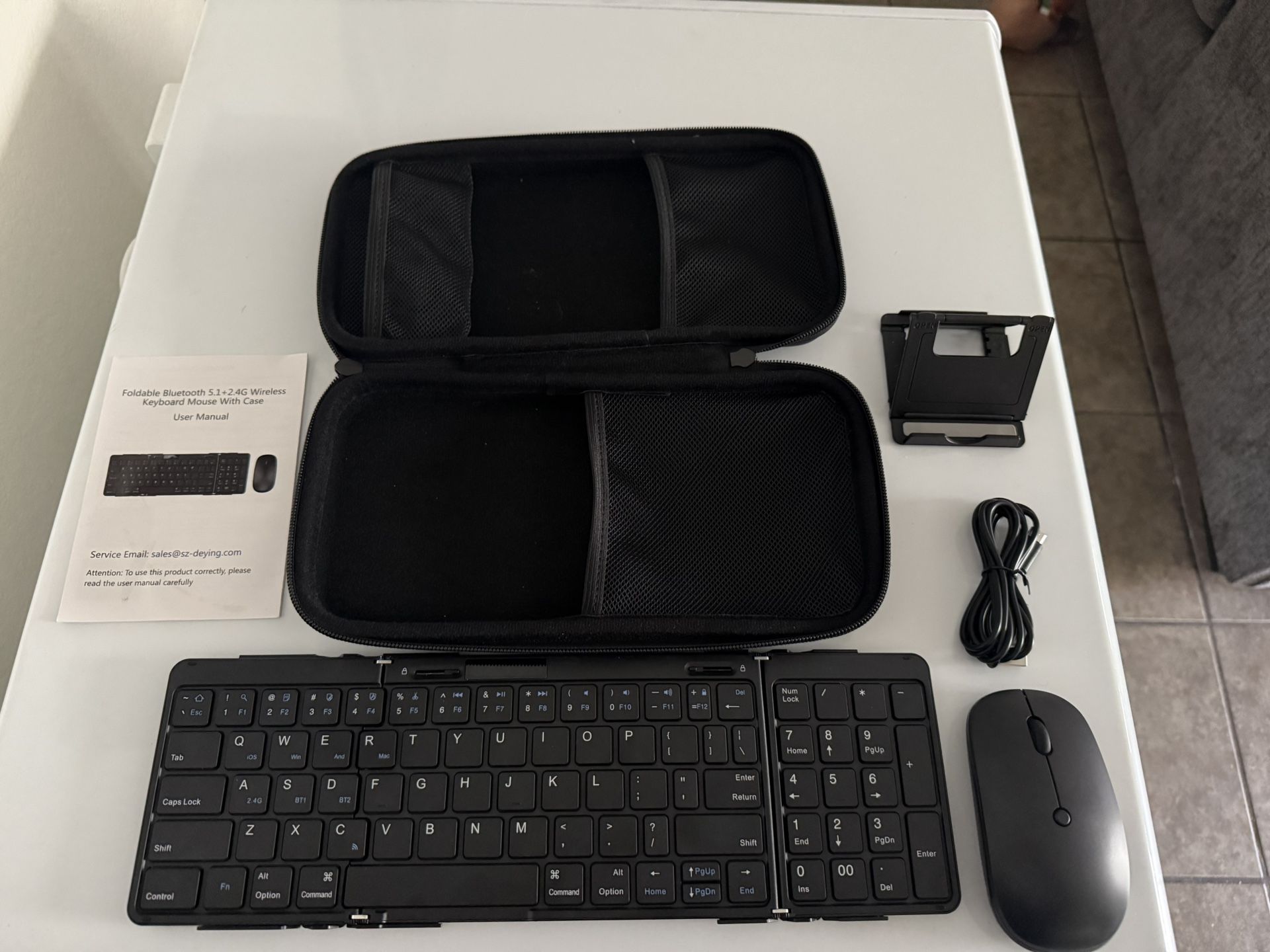 Portable keyboard with phone, stand mouse and case. Also, A plug.