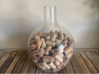 Vintage clear Demijohn bottle filled with wine stoppers