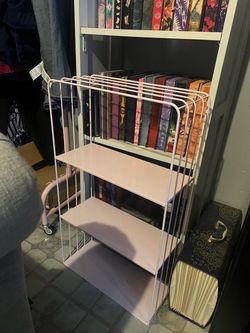 A white able to hang up three story shelf , very cute