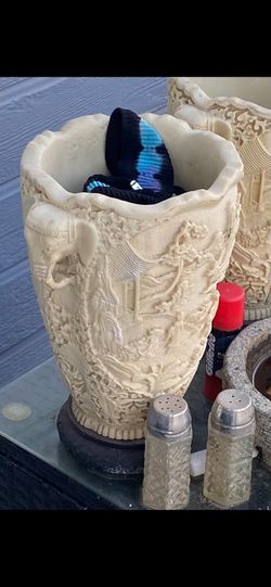 Antique faux ivory vase with 3D relief carvings and elephant head handles