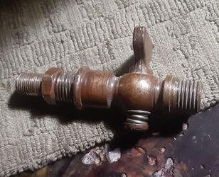 This item is an antique brass gas shut-off valve or petcock