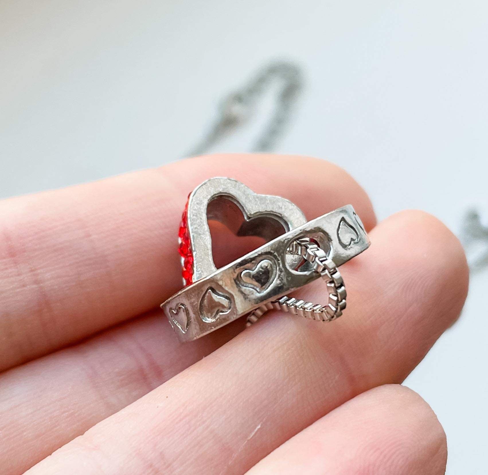 Two silver necklaces with red gemstones