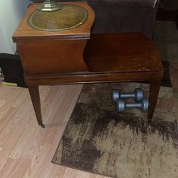Antique side table has the rolling wheels