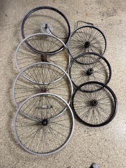 An assortment of seven bicycle wheels