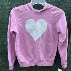 This is a pink DKNY hoodie with a bright heart in the center. Size L (12)