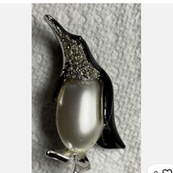 black enamel and rhinestone penguin brooch with a large faux pearl belly