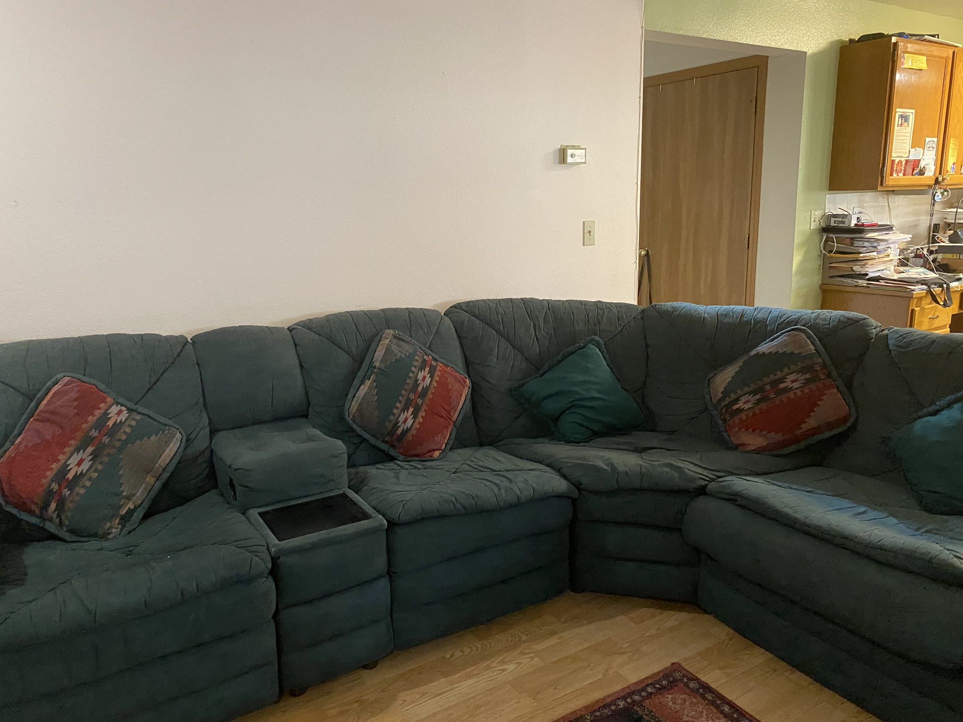 Green Sectional Sofa With Sleeper and cushions