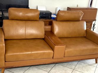 2 Set of  Tan Leather Sofa with Wood center console. Includes outlets and USB charger ports.
