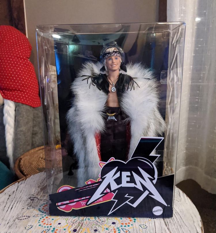 Barbie The Movie Collectible Ken Doll Wearing Big Faux Fur Coat and Black Fringe Vest with Bandana