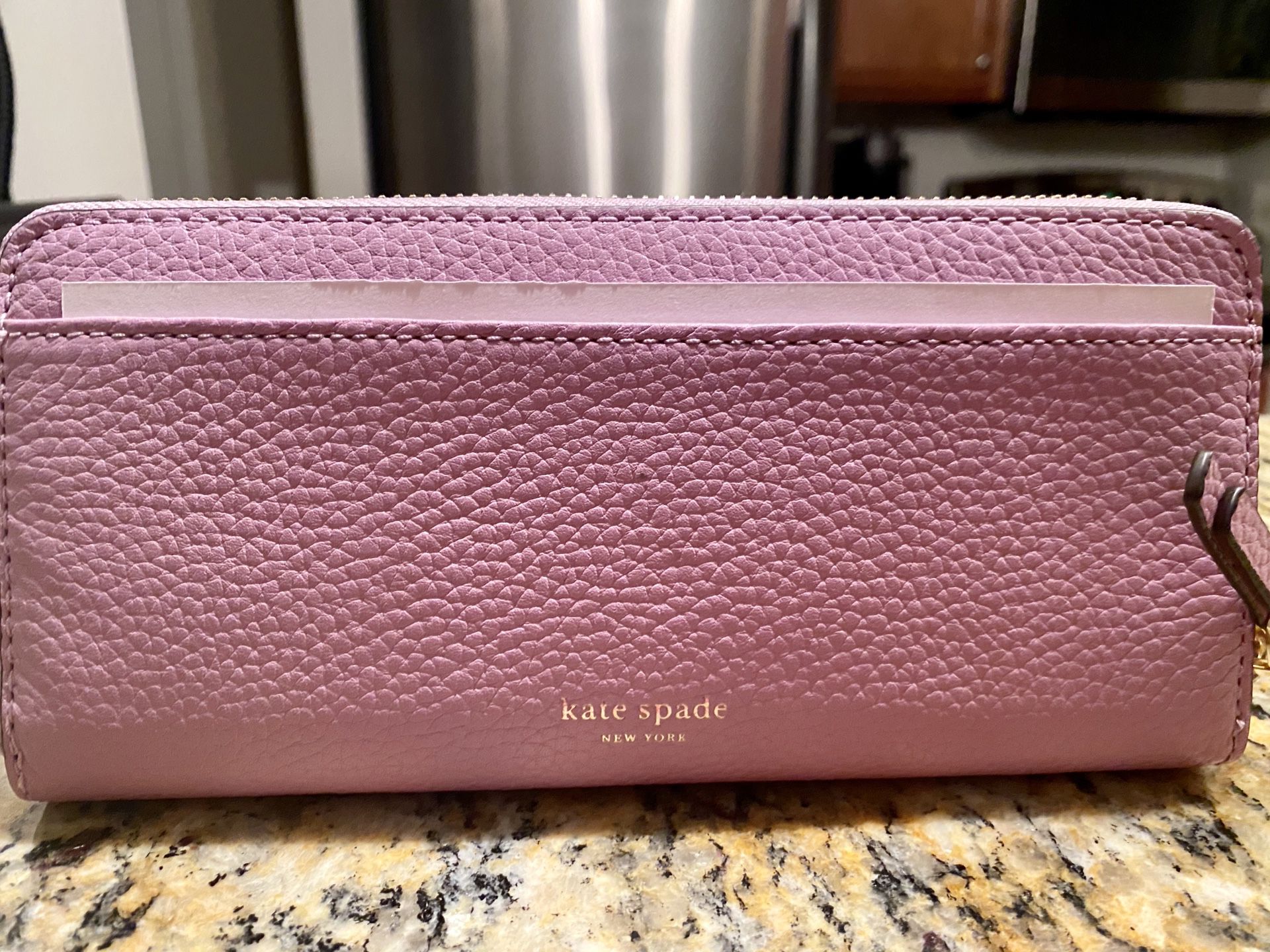 Kate Spade wallet , still brand new with Lilac color leather .