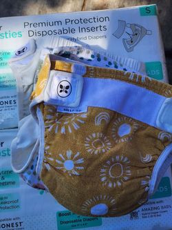 Reusable Covers: The patterned cloth items are The Honest Company Hybrid Diaper Covers
