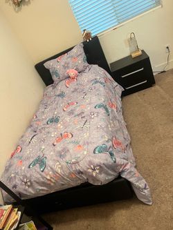 Black twin size bed with night stand