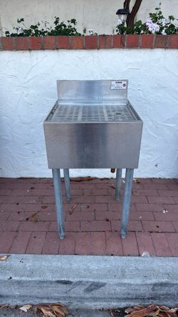 Professional-grade Krowne stainless steel underbar drainboard unit featuring a perforated top insert, integrated backsplash, and heavy-duty galvanized