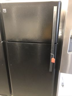 Used Kenmore top and bottom freezer. 1 year warranty