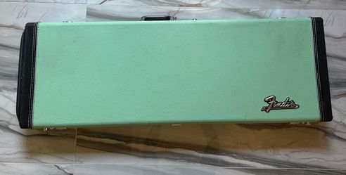 Fender Deluxe Hardshell Electric Guitar Case in Surf Green/Seafoam Green with a plush blue interior