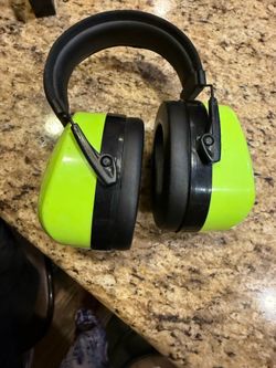 Uline neon lime earmuffs are a high-visibility safety product with a noise reduction rating of 28 dB.