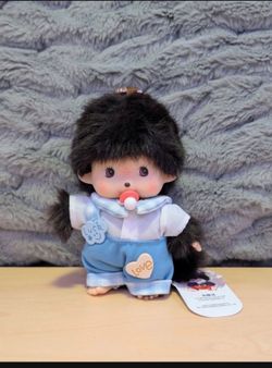 Monchhichi doll with a school boy outfit. Looks like “Punch” the monkey