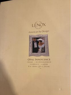 Lenox decorative photo frame with ornate embossed border. Subtle reflective silver-tone finish highlights detailing. Ideal for showcasing a special po