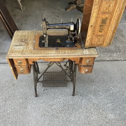 Vintage 1876, Antique White Rotary pedal treadle sewing machine And Table.  Made in the USA. Brand is white. 