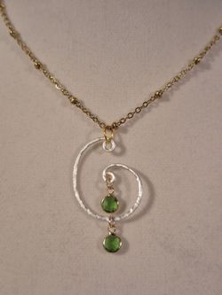 Silver circle pendant with green stone