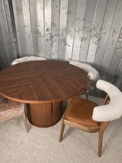 Dark brown round fluted dining table with chairs