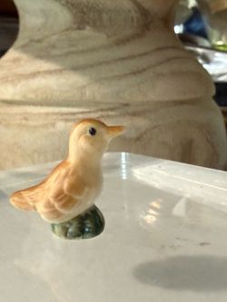 Itty Bitty Miniature Sweet Bird Figurine Trinket   Made of ceramic, light brown color with dark eyes. Has a small green base.