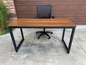 Office table with metal base and black leather chair
