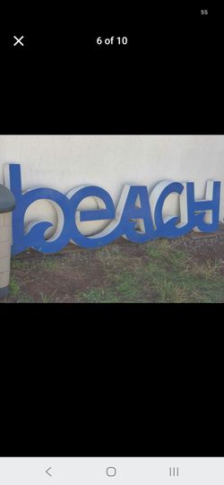 Large vintage beach sign with wavy cutout letters