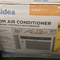 Midea 5,000 BTU Room Air Conditioner with electronic controls and a remote