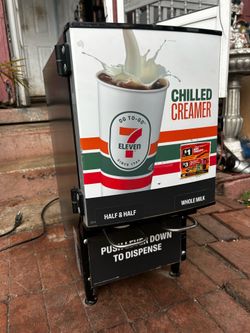 Working  7-Eleven Chilled Creamer dispenser used in convenience stores for dispensing liquid creamer into coffee.The machine features a two-head dispe