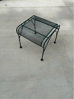 green wrought iron table is a vintage patio side table