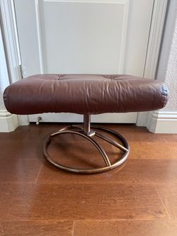Vintage Brown Leather Ottoman with a Copper-Bronze Curved Metal Swivel Base