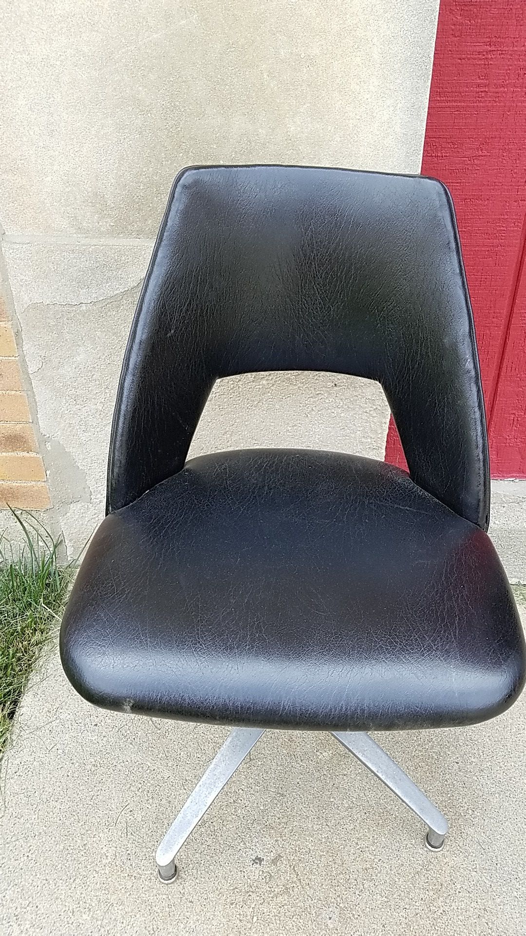 MCM black studded vinyl swivel chair